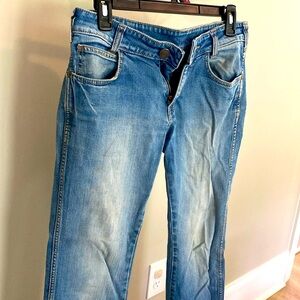 Broken in . Very well loved. Worn and faded. Very soft. Slim bootcut wranglers